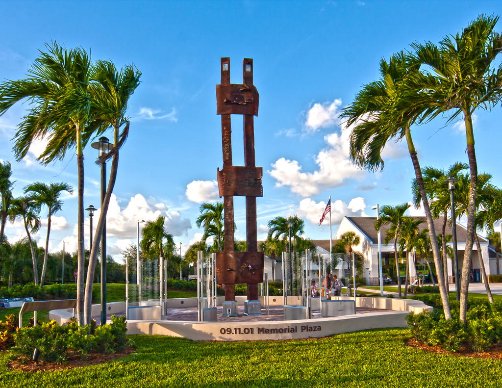 View of statue in September 11, 2001 Memorial Plaza with trees around courtyard area where memorial stands